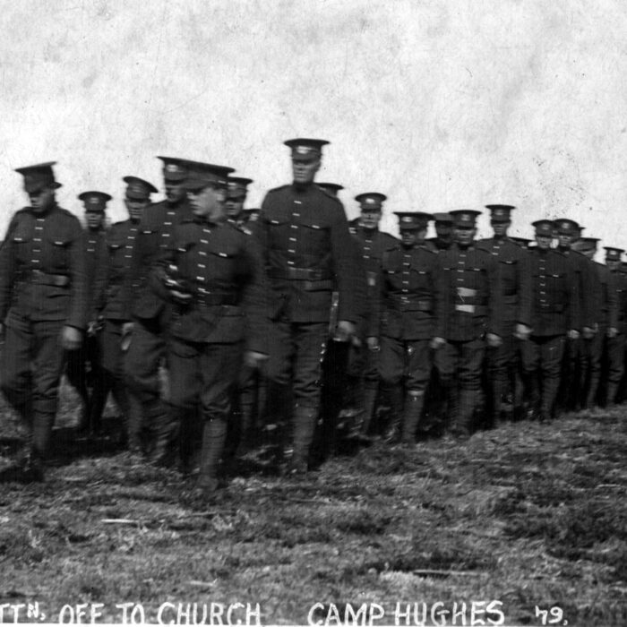 108th Battalion - Off to church Camp Hughes, Date Unknown, War Time Canada Two rows of soldiers walk across the frame. Text along the bottom reads '108th Battalion off to church, Camp Hughes'