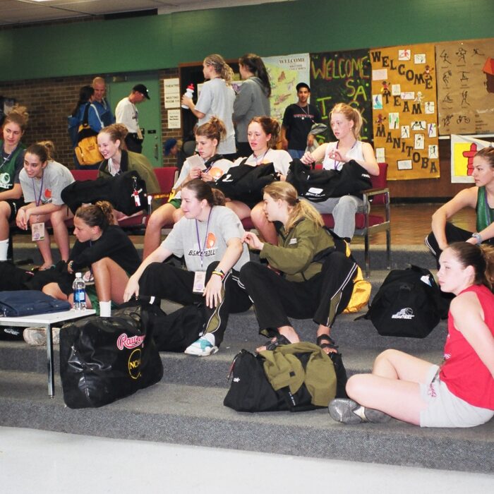 Group of people inside school sitting on steps