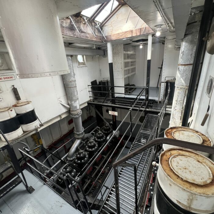 C. G. S. Bradbury Engine Room, 2026, Selkirk Museum Collection Colour photo of the interior of a ship's engine room. There is a lot of metal and platforms with stairs surrounding the engine