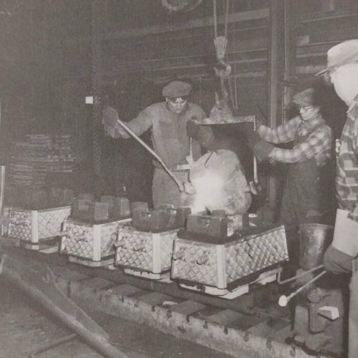Black and white portrait of men working in the Rolling Mills