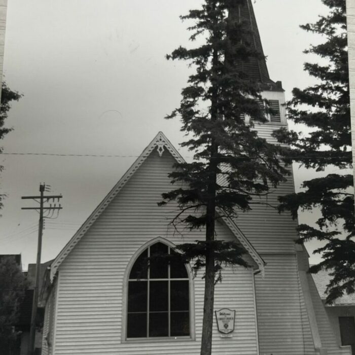 Black and white photo of Christ Church with tree in front
