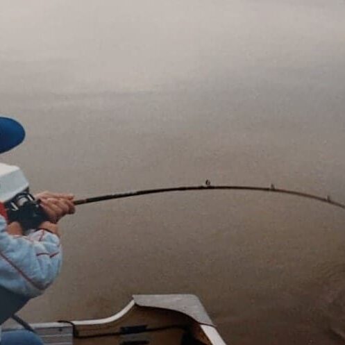 Cover image of Chuck teaching a young child how to fish