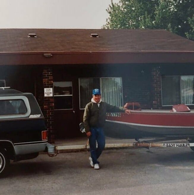 Chuck Norquay posing in front of his boat