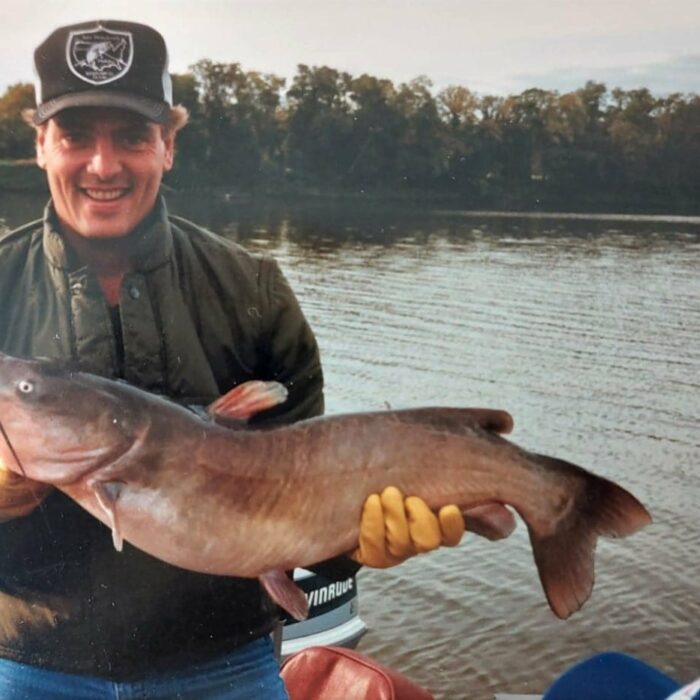 Chuck Norquay posing with a large catfish