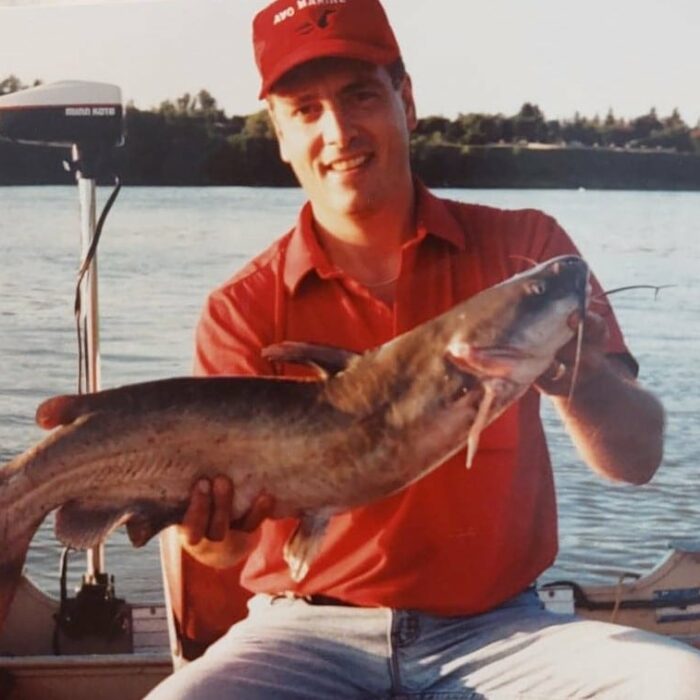 Coloured portrait of Chuck holding a large catfish