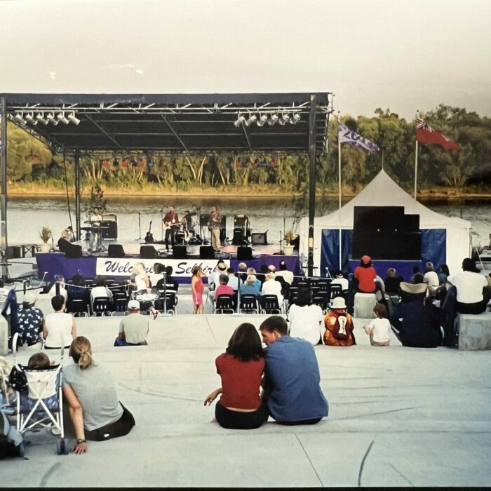 Color photo of a concert at the water front