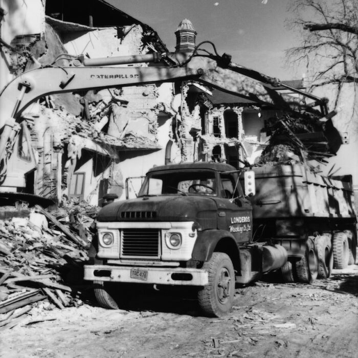 Demolition of Selkirk Mental Hospital 4, Date Unknown, Madness Canada Black and white photo of an excavator loading up a dump truck
