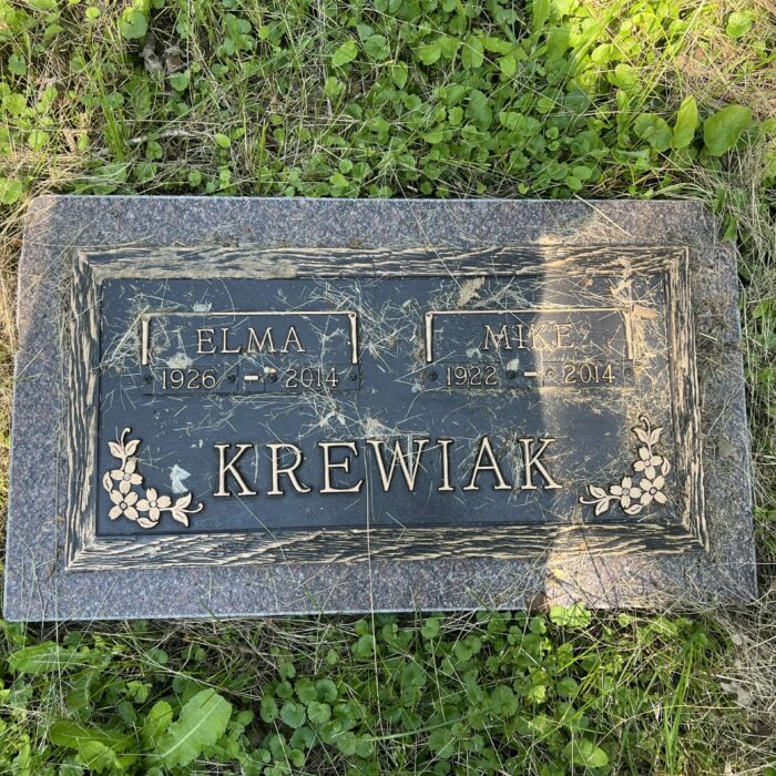 Colour photo of a gravestone with the name 'Krewiak'