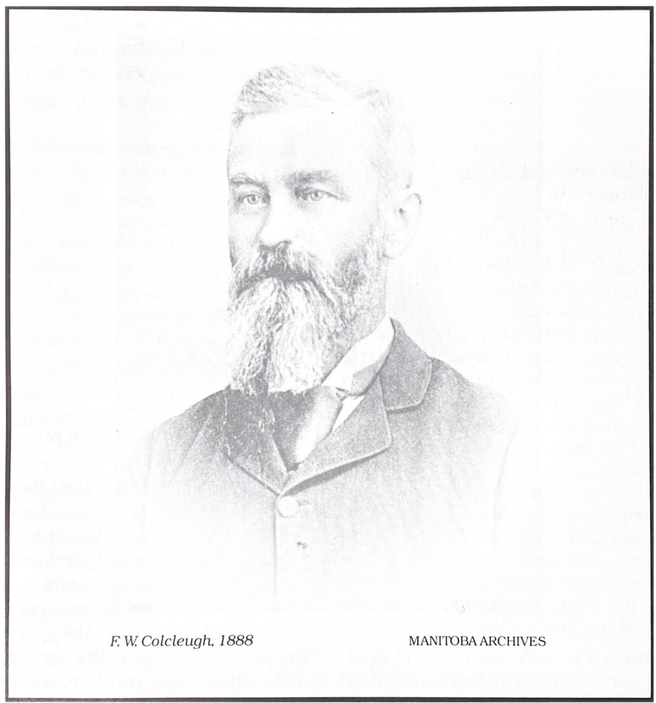 Black and white photo of a middle-aged man wearing a suit and tie. He has a long chest-length beard