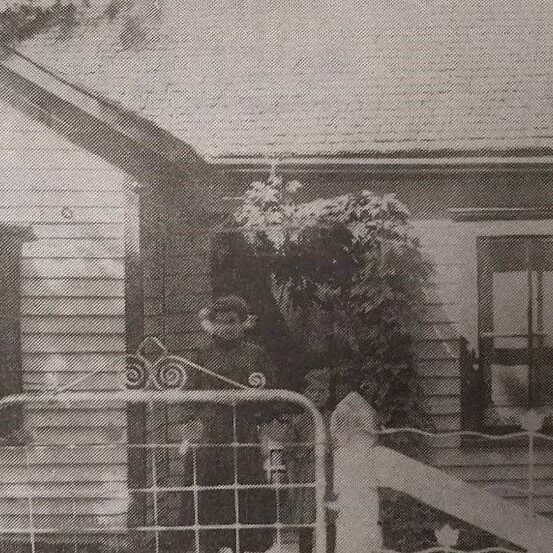 Fergusson House at 131 McLean Ave, Date Unknown, Selkirk Enterprise Centennial A black and white photo of a house. The house is asymmetrical with two windows on the left and a smaller window on the right. There is a fence with a wire gate at the front of the image