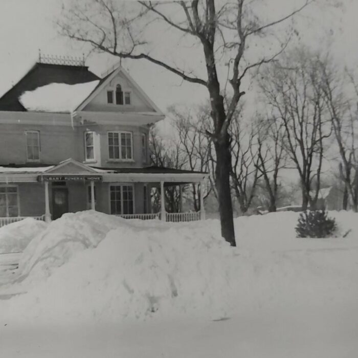 Gilbart Funeral Home, Date Unknown, Wes Gilbart Black and white photo of a large three story house in the snow. There are a few trees on the right side of the photo without leaves and one larger tree in the front yard