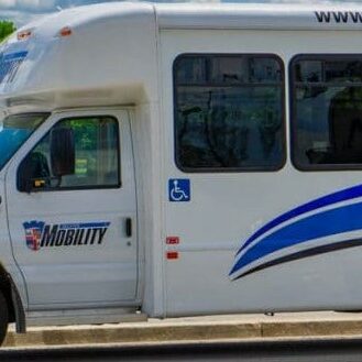 Colour photo of a bus parked along the side of the road
