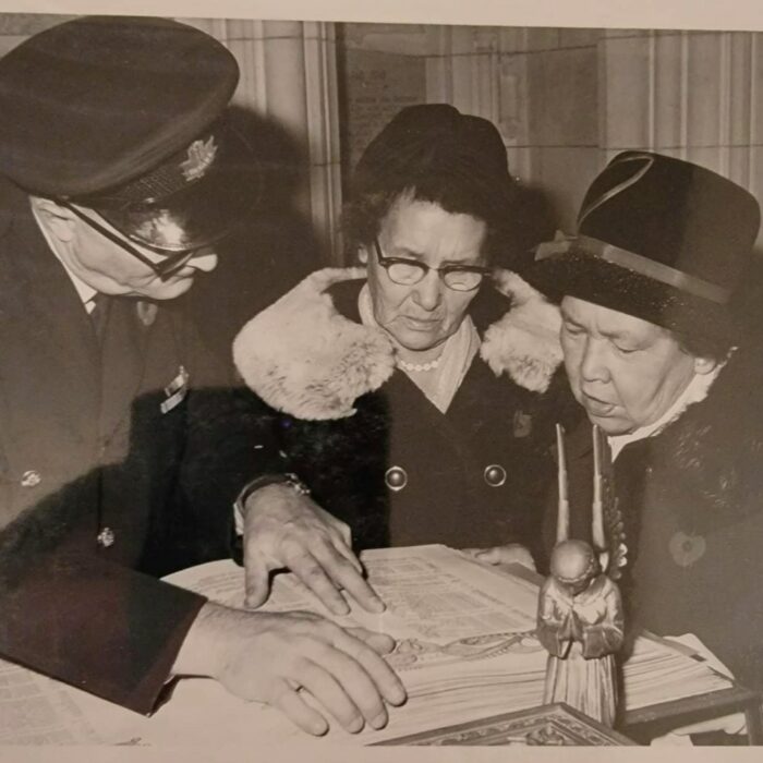 Black and white photo of Amy Clemons with a woman and a man