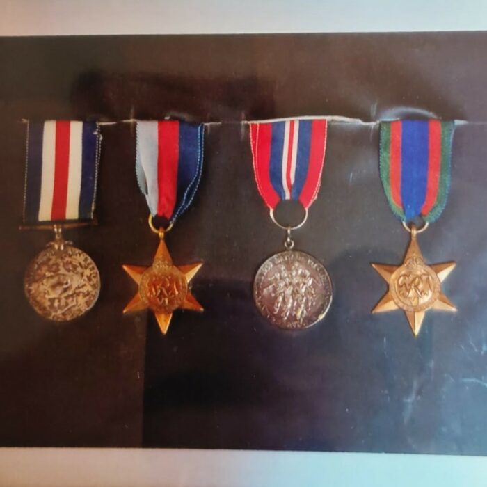 John V. Sinclair Medals, GEORGIVS VI Coin, France + Germany Star, 1939 Canada 1945 Voluntary Service Voluntaire, and 1939-1945 Star, 1939-1945, Mae Gulewich Colour photo of four medals framed on a black background