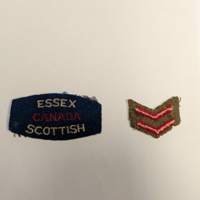 John V. Sinclair Military Badges, 1945, Mae Gulewich Colour photo of two badges on a white background