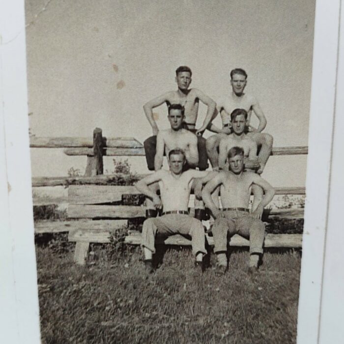 John V. Sinclair with Group of Young Men, Date Unknown, Mae Gulewich Black and white photo of a group of men sitting beside a lake