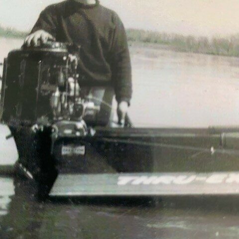 John at the Selkirk Regatta, 1966, Mary Shumilak Man next to the engine in a boat in a body of water