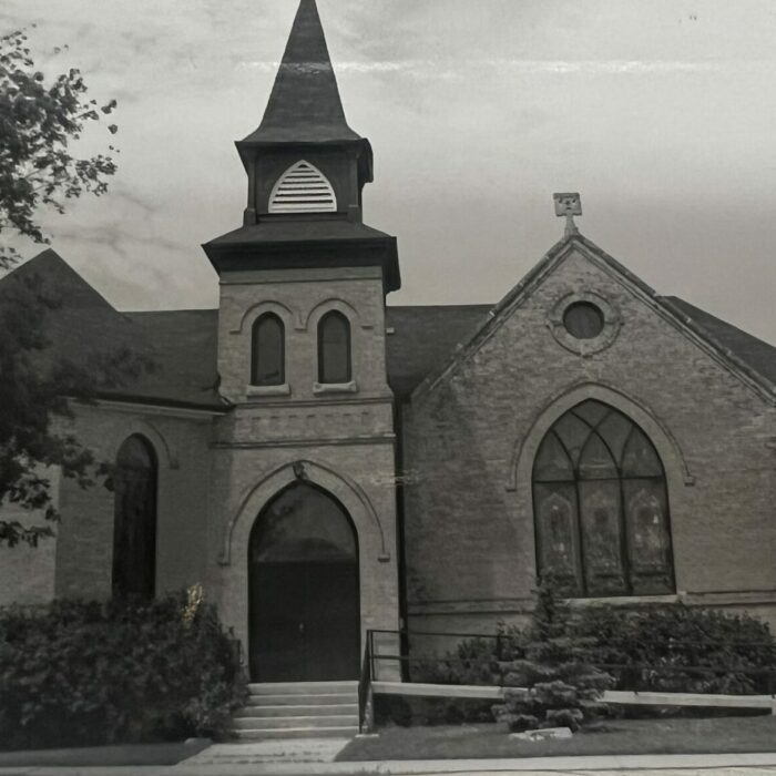 Black and white photo of the entrance side of the church