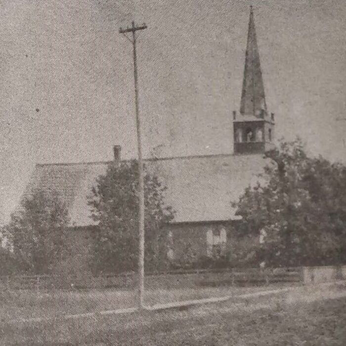 Knox Presbyterian Church Looking East on McLean Avenue, c1900, Selkirk Enterprise Centennial A black and white image of a church from across a street