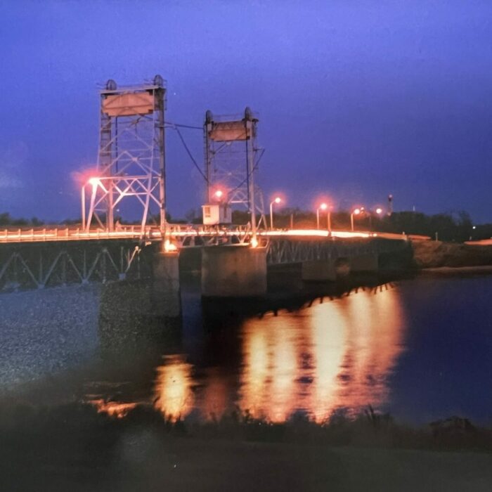 Lift Bridge at Night, 2001, Selkirk Museum Collection Lift bridge at night, the light from the bridge is reflecting off the river.