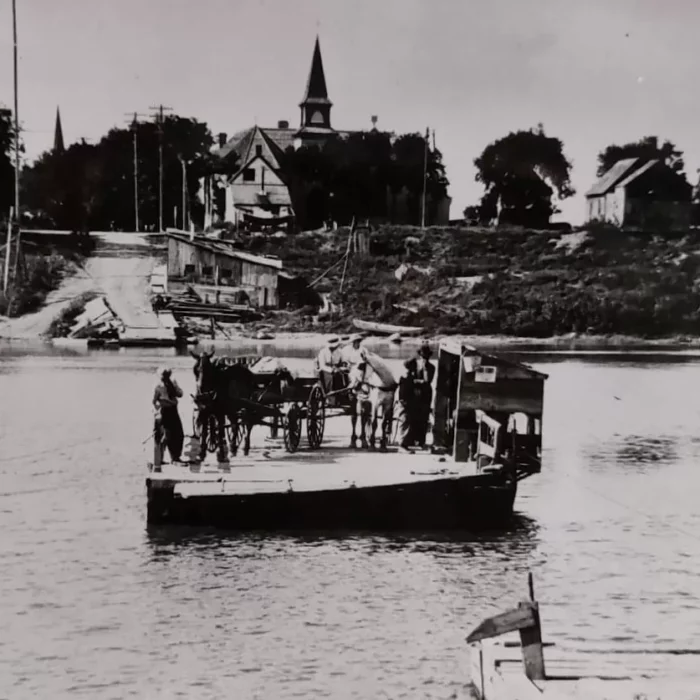 The Selkirk Ferry Coming from Dock at the End of McLean Avenue, c1905, Manitoba Archives Black and white photograph showing a ferry and Knox church in the background.