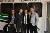 Selkirk Transit staff taking a picture in front of the transit bus