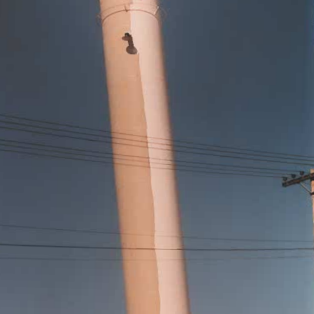 Colour photo of the middle portion of the Selkirk Water Tower. There are powerlines running horizontally across the image