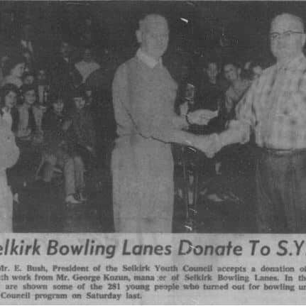Selkirk Bowling Lanes Donate To S.Y.C., 1961, Selkirk Enterprise Photo of Mr. E. Bush President of the Selkirk Youth Council accepting a donation from Mr. George Kozun