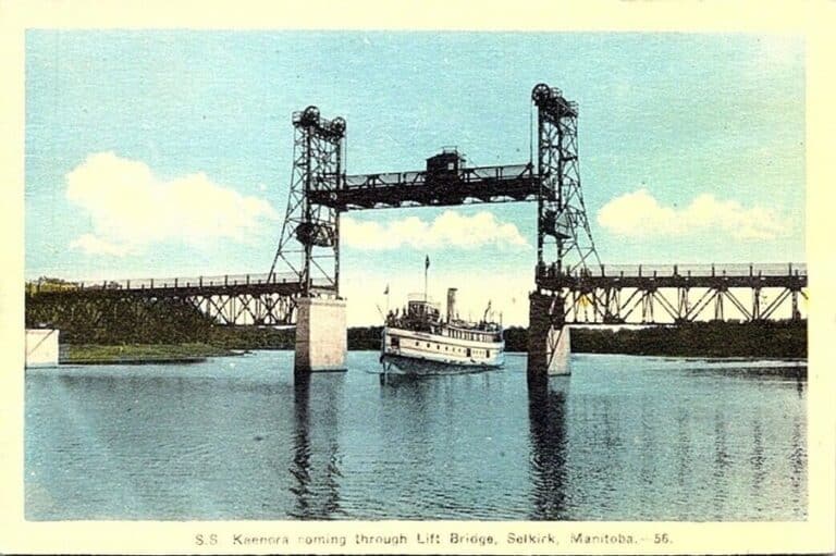 Photo of the S.S. Keenora going under the lifted Selkirk Lift Bridge
