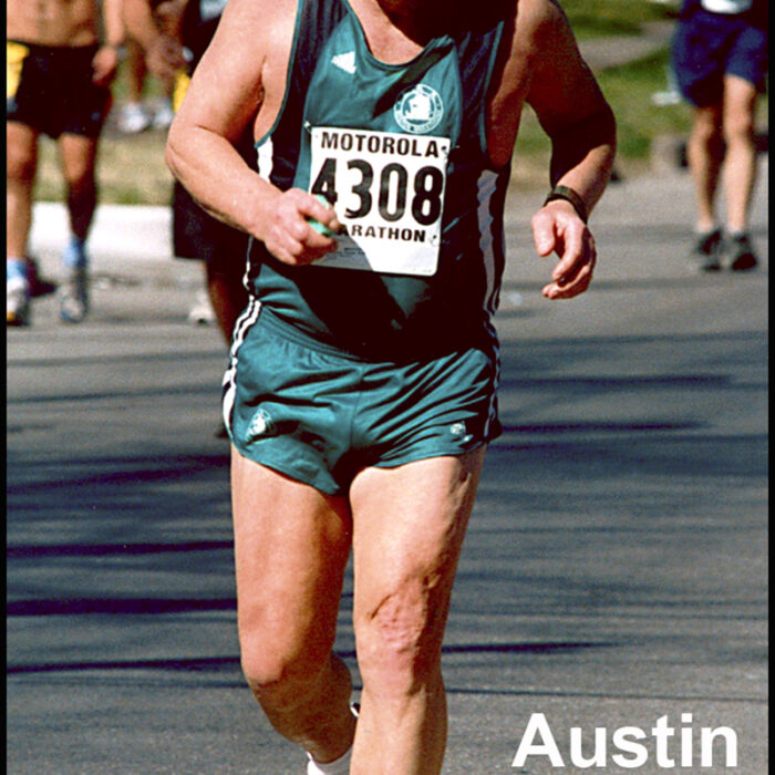 Podruchny at Austin TX, 2002, Thomas Podruchny Man running towards camera wearing a green and black shirt and green shorts. The number 4308 is pinned to his shirt. The letters 'Austin TX' are printed in the bottom right corner