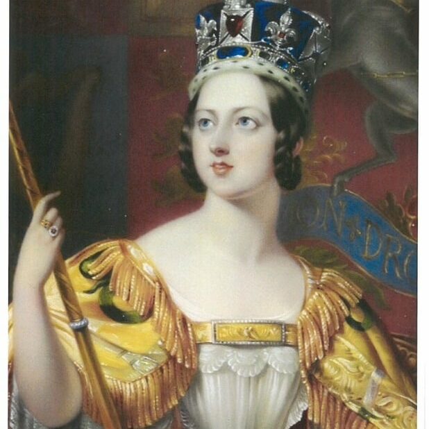Photo of Queen Victoria holding a staff, wearing a yellow dress, with a blue royal piece of headwear on