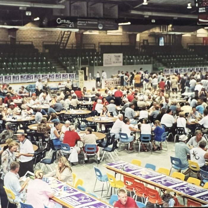 color photo of a bunch of tables with people