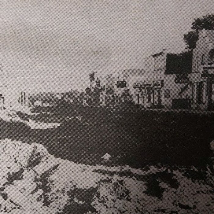 Repaving Manitoba Avenue, 1965 Selkirk Enterprise Centennial Edition Black and white photo of Manitoba Avenue. The road is broken up into large chunks of dirt and concrete in the process of being repaved