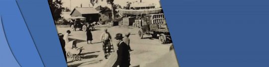 Robinson Header Picture of a busy Robinson Avenue from the 1990s. The road is occupied by a truck moving materials, people walking and biking.