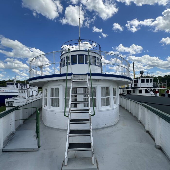 S. S. Keenora Exterior Boat Top, 2026, Selkirk Museum Collection Colour photo of the top deck of the Keenora. The blue sky is filled with clouds