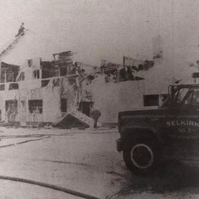 All that Remained of the Eveline Hotel Fire, 1970, Rob Scherza Fire Trucks in front of a burned building. There is a firetruck in the foreground of the image with the burned building in the background.