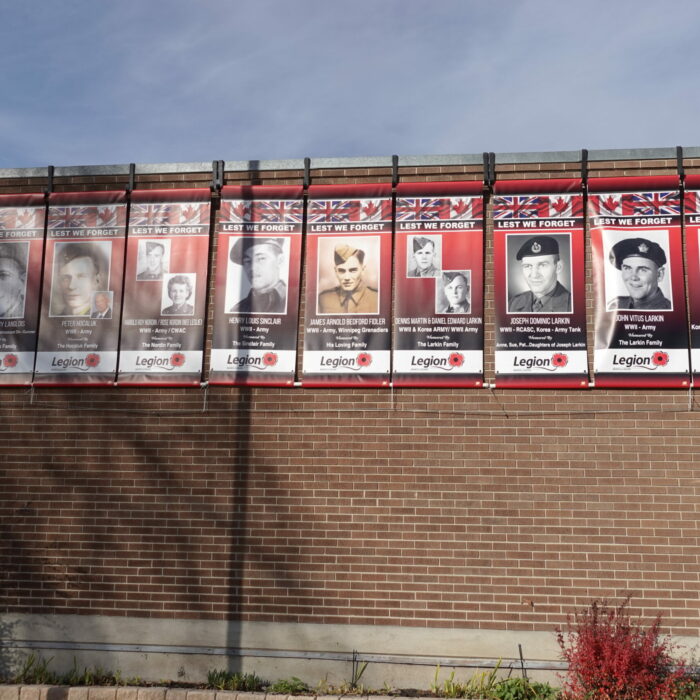 A colour photo of the exterior of the Legion. There are multiple banners hanging from the side of the building