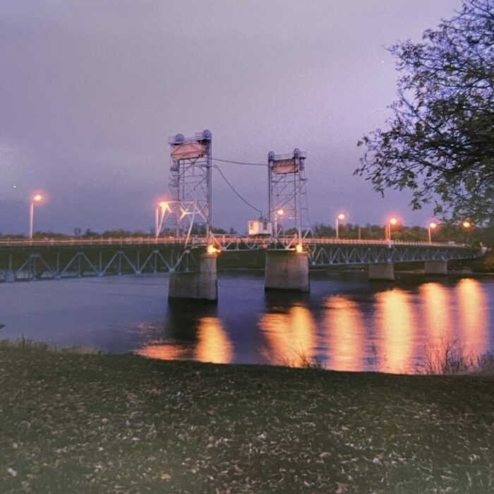 Selkirk Lift Bridge Night Time, 2001, Selkirk Museum Collection Lift bridge at night, the light from the bridge is reflecting off the river.