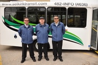 Selkirk Transit bus drivers standing in front of the Selkirk Transit bus