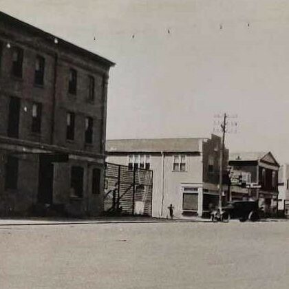 Southwest Corner of Manitoba Avenue, 1945, Selkirk Remembered by Hugh H. Gibbs Black and white photo of Manitoba Avenue. There are several buildings on this side of the street. The first building on the left is a three-story brick building