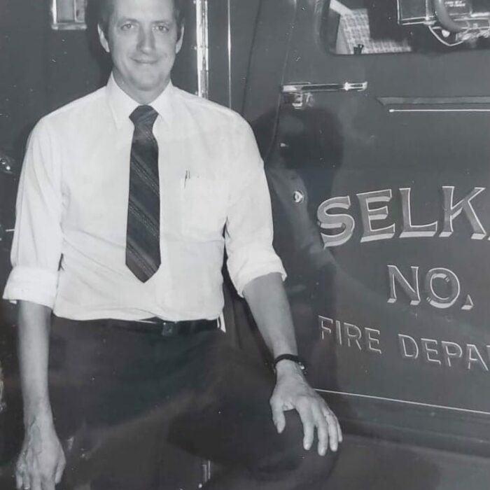 Retired Fire Chief Ted Wozny, Date Unknown, Ted Wozny Portrait of Ted Wozny posing in front of a fire truck