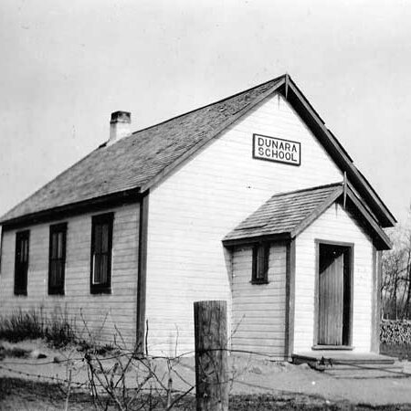Black and white image of a small schoolhouse building