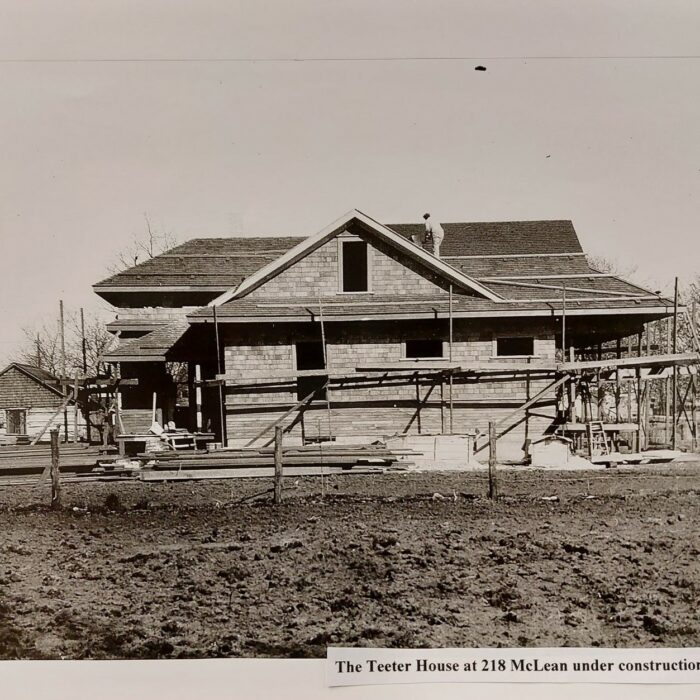 The Teeter House at 218 McLean Under Construction, 1916, Selkirk Museum Collection A black and white photo of a large wooden house. There is an open field in front of the house