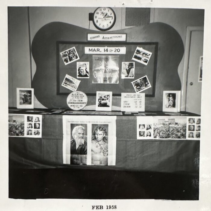 A black and white photo of the ticket booth at the Garry Theatre decorated by theme