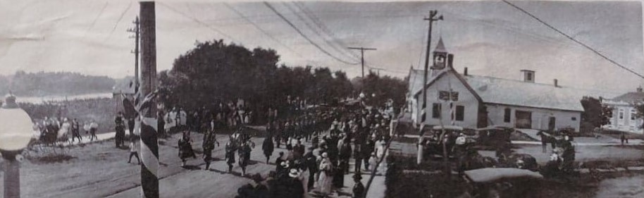 A black and white image of Eveline Street and Eaton Avenue. There are people in the street and Town Hall is shown on the right of the image