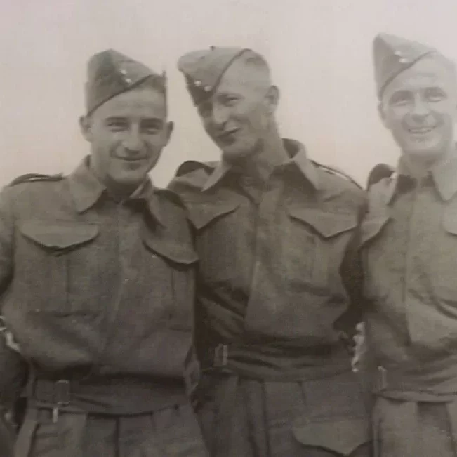Uncle Bill, George, and Dad Jock Visit Home at Hecla Before Shipping Out for Basic Training, Jock Langlois Three men posing together in uniform smiling