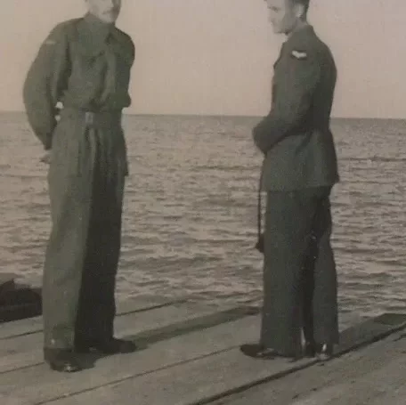 Uncle Bill and Ted Visit Hecla Before Shipping Out, Date Unknown, Jock Langlois Two men standing on a dock in Hecla in uniform