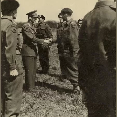 Uncle Standing at Attention Receiving his Sergeant Stripes from King George Sixth, Date Unknown, Jock Langlois Black and white portrait of a man shaking hands in uniform