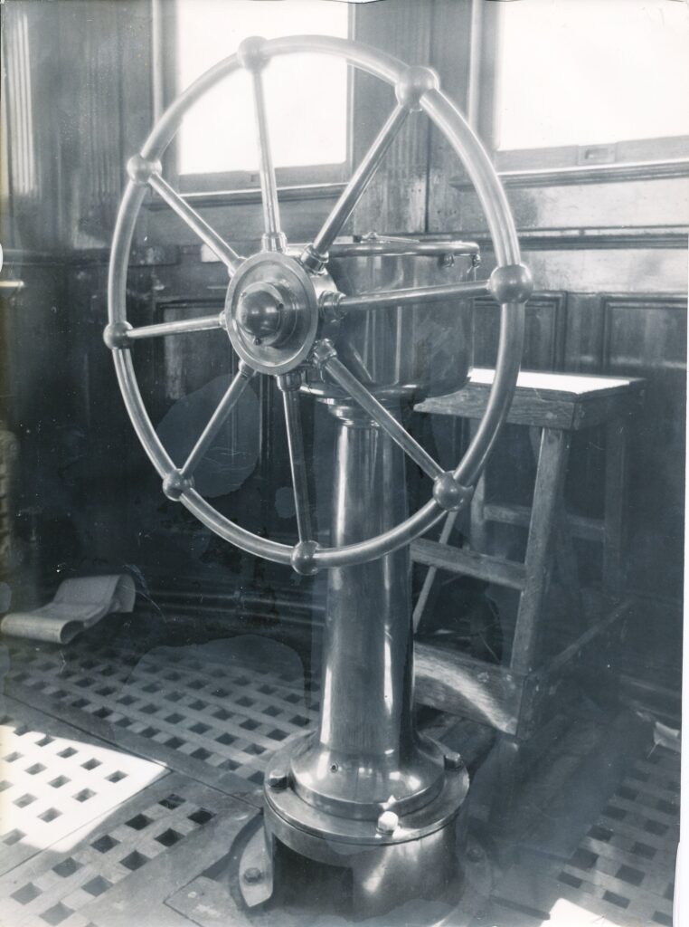 Wheel at the helm of the Bradbury interior, 1950s, source unknown