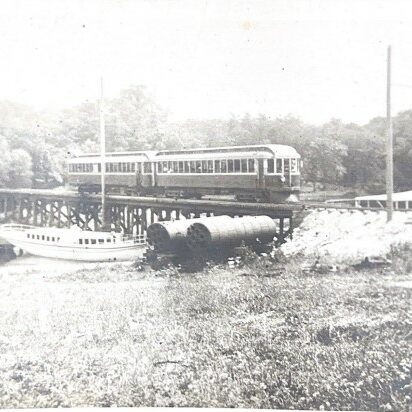 Black and white photo of the street car crossing a bridge